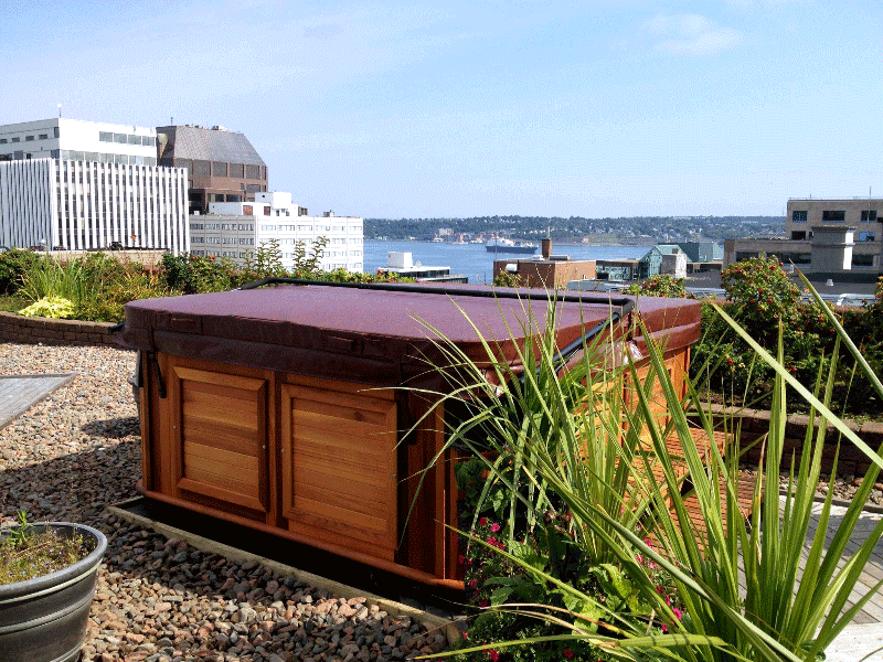 Covered Arctic Spas hot tub in the backyard overlooks a city